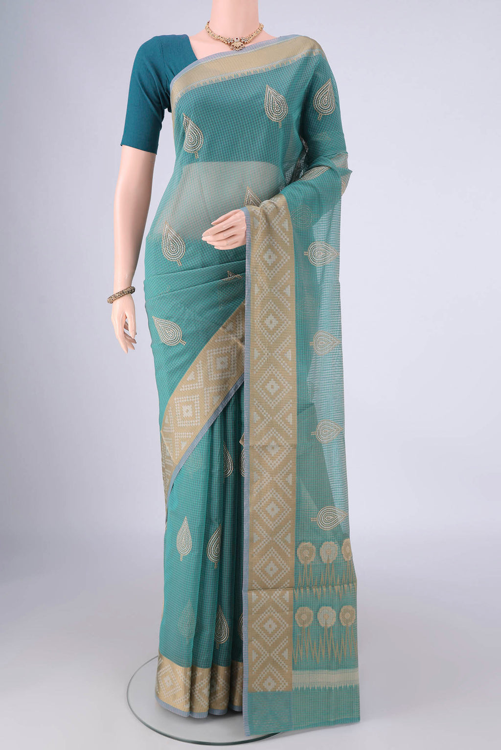 Sea Green Blended Kota Cotton Saree with Embroidery on the body and Zari Border.  displayed on a mannequin
