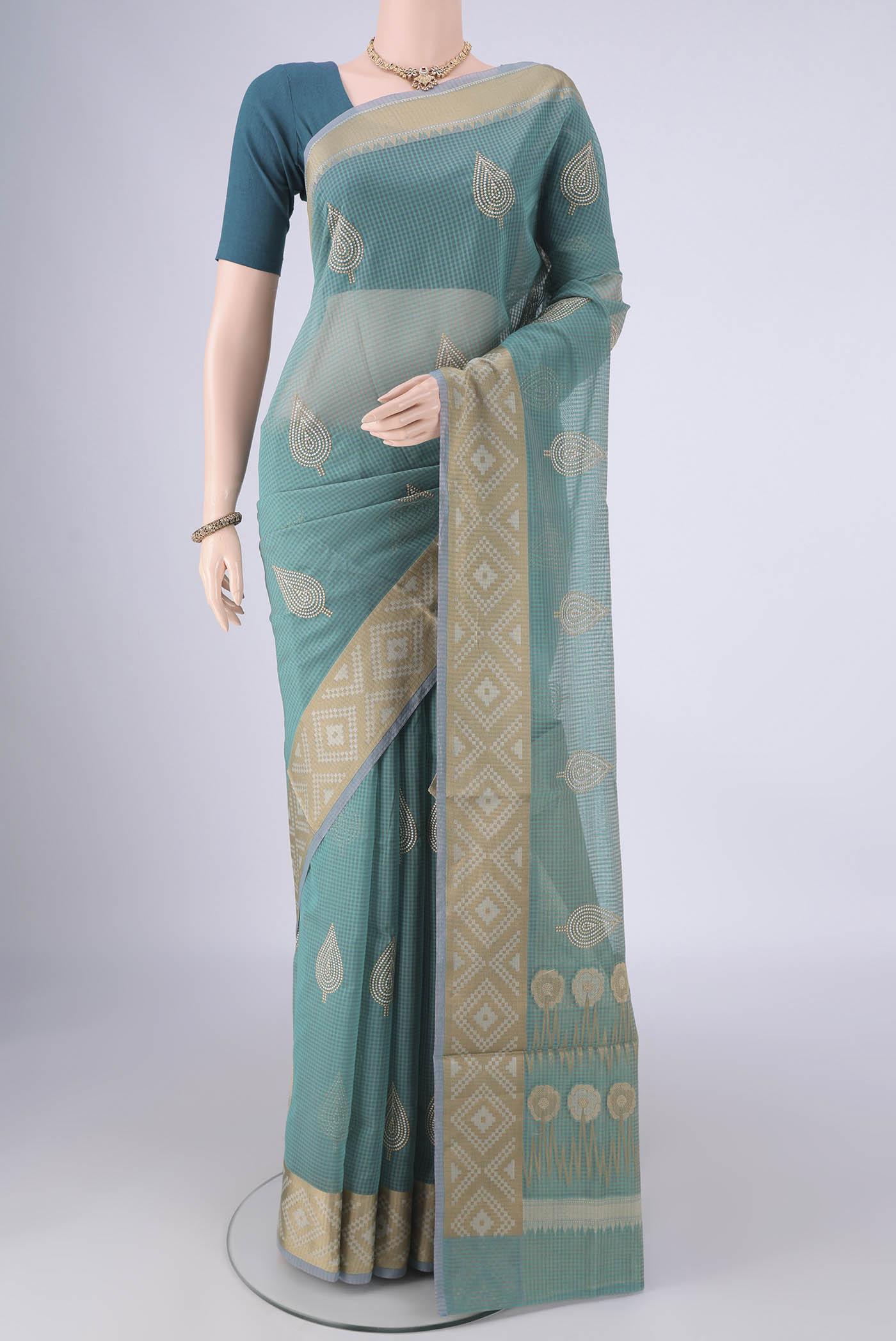 Sea Green Blended Kota Cotton Saree with Embroidery on the body and Zari Border.  displayed on a mannequin
