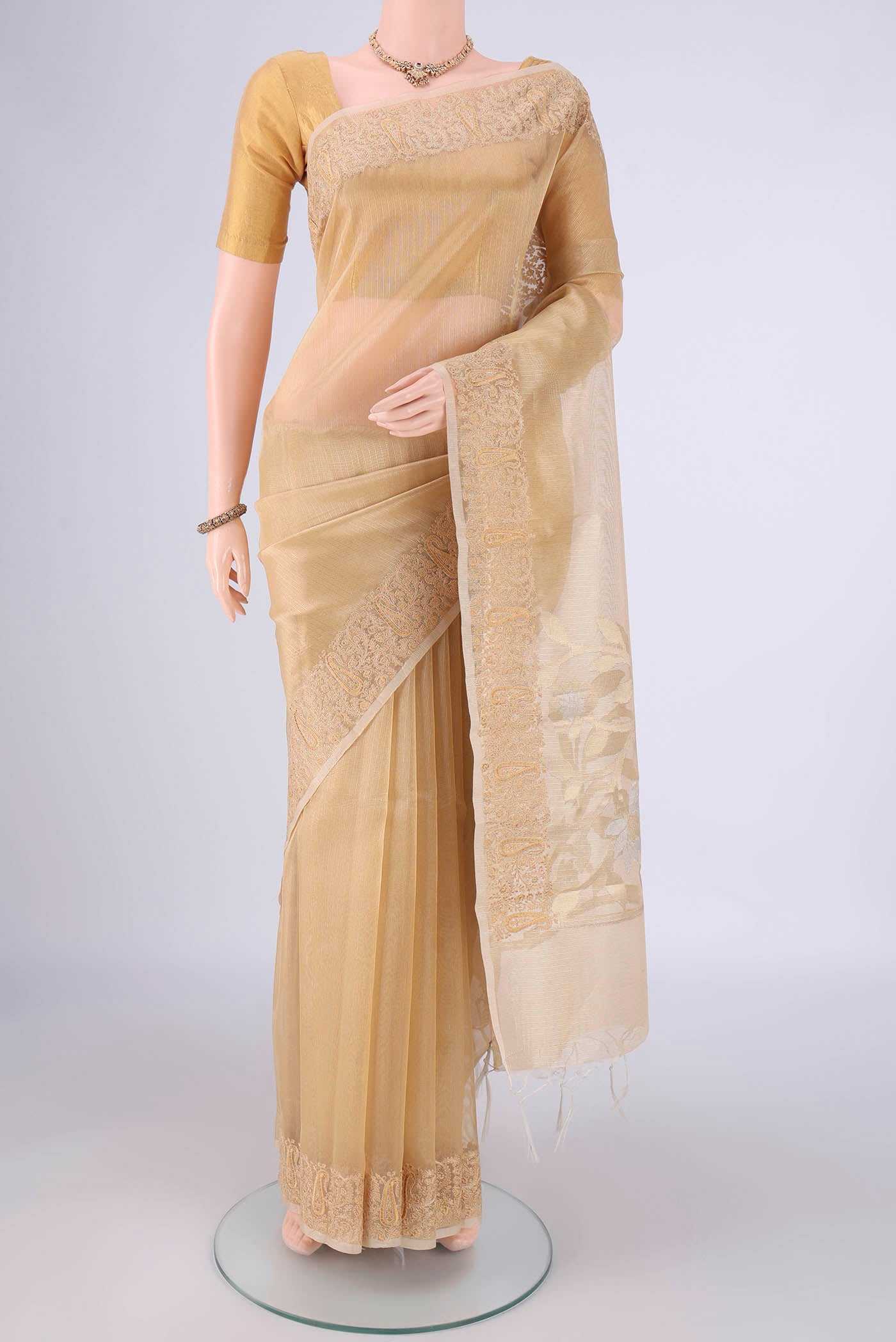 Golden Blended Kota Cotton Saree with Stripes on the body and Embroidery Border.  displayed on a mannequin