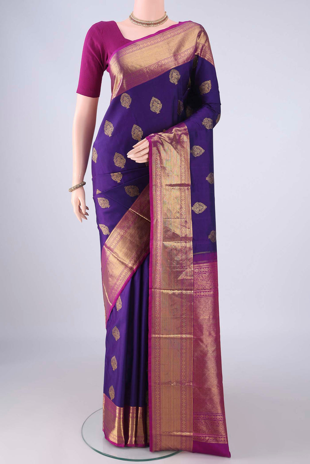 Blue Kanjivaram Silk Saree with Zari Butta on the body and Zari Border.  displayed on a mannequin