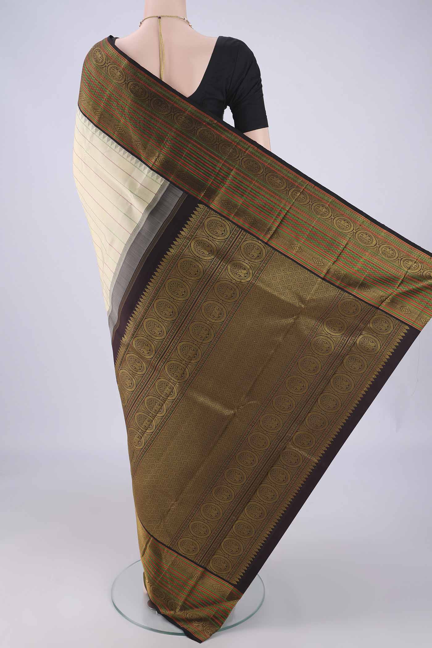 Flat view of Cream Dual Tone Kanjivaram Silk Saree with Veldhari on the body and Thread Border. 