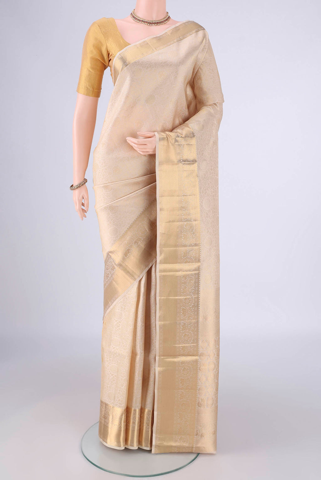Off White Soft Silk Saree with Zari Brocade on the body and Zari Border.  displayed on a mannequin