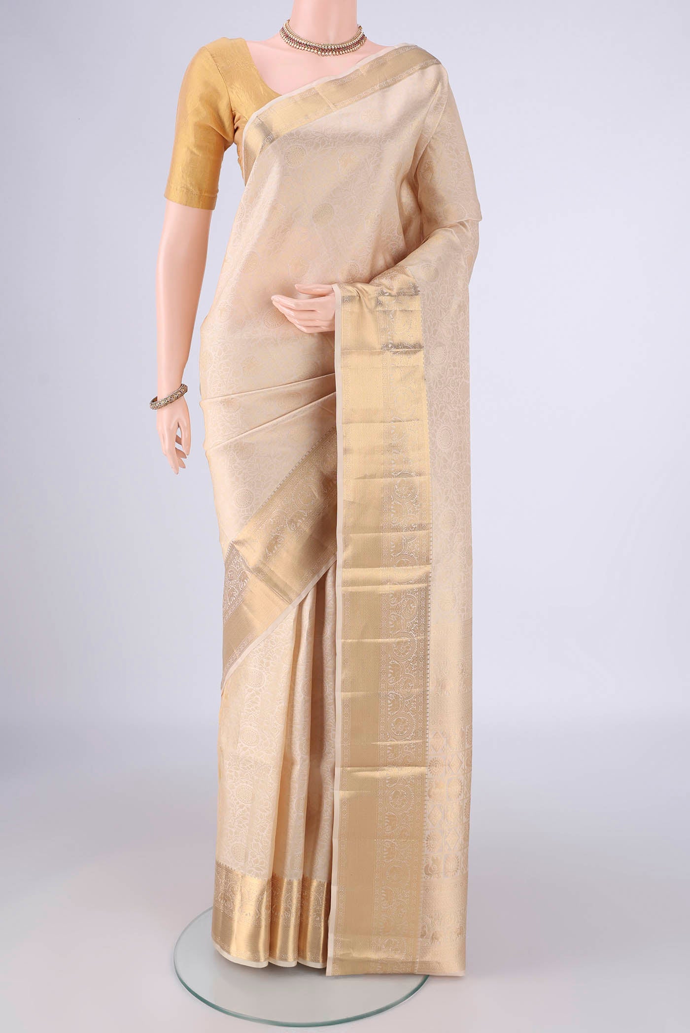 Off White Soft Silk Saree with Zari Brocade on the body and Zari Border.  displayed on a mannequin