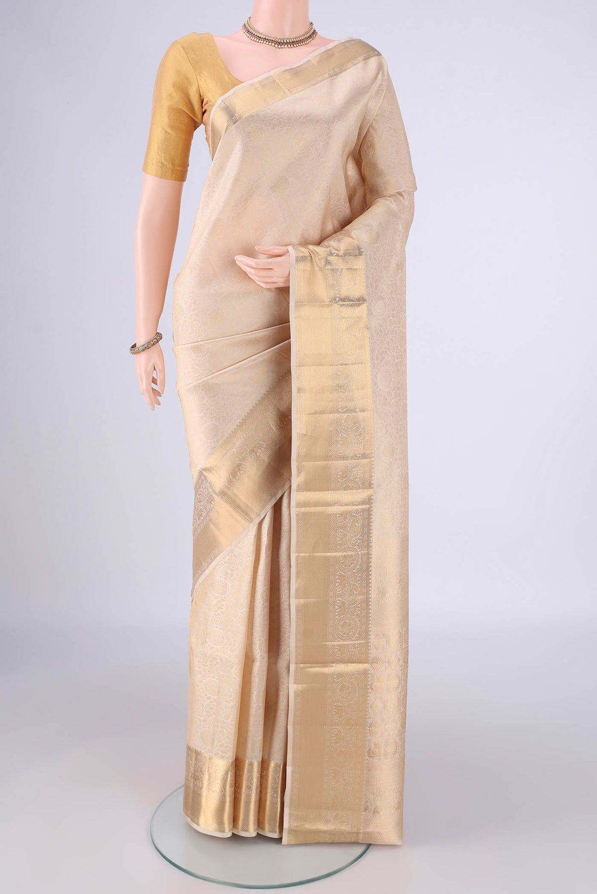Off White Soft Silk Saree with Zari Brocade on the body and Zari Border.  displayed on a mannequin