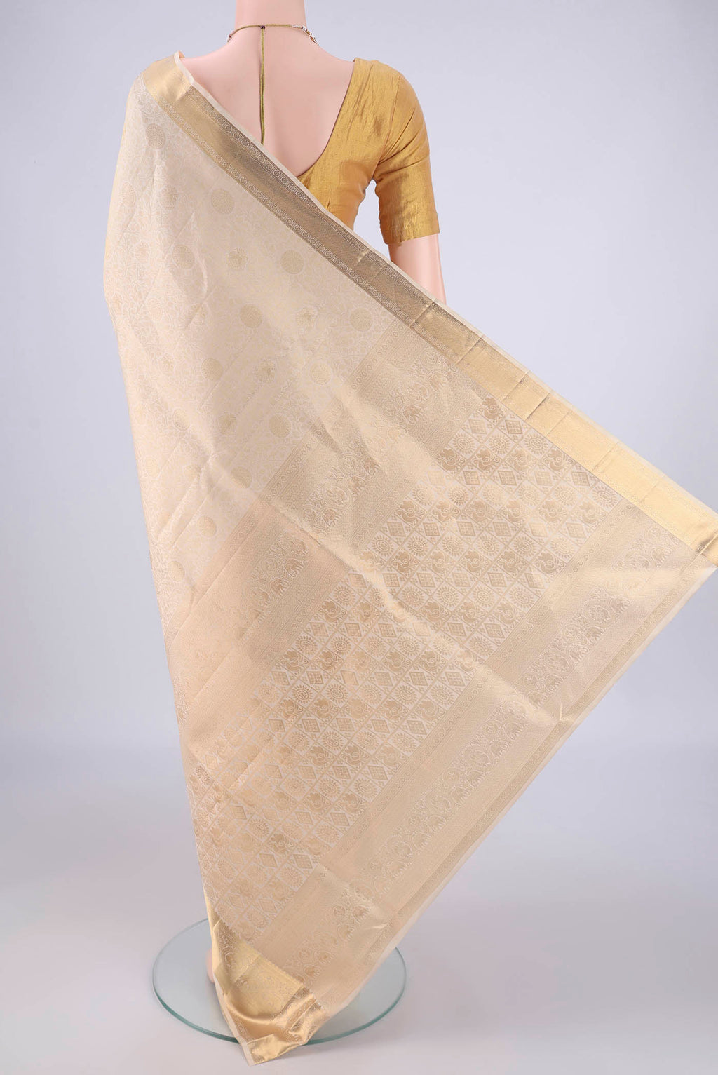Flat view of Off White Soft Silk Saree with Zari Brocade on the body and Zari Border. 