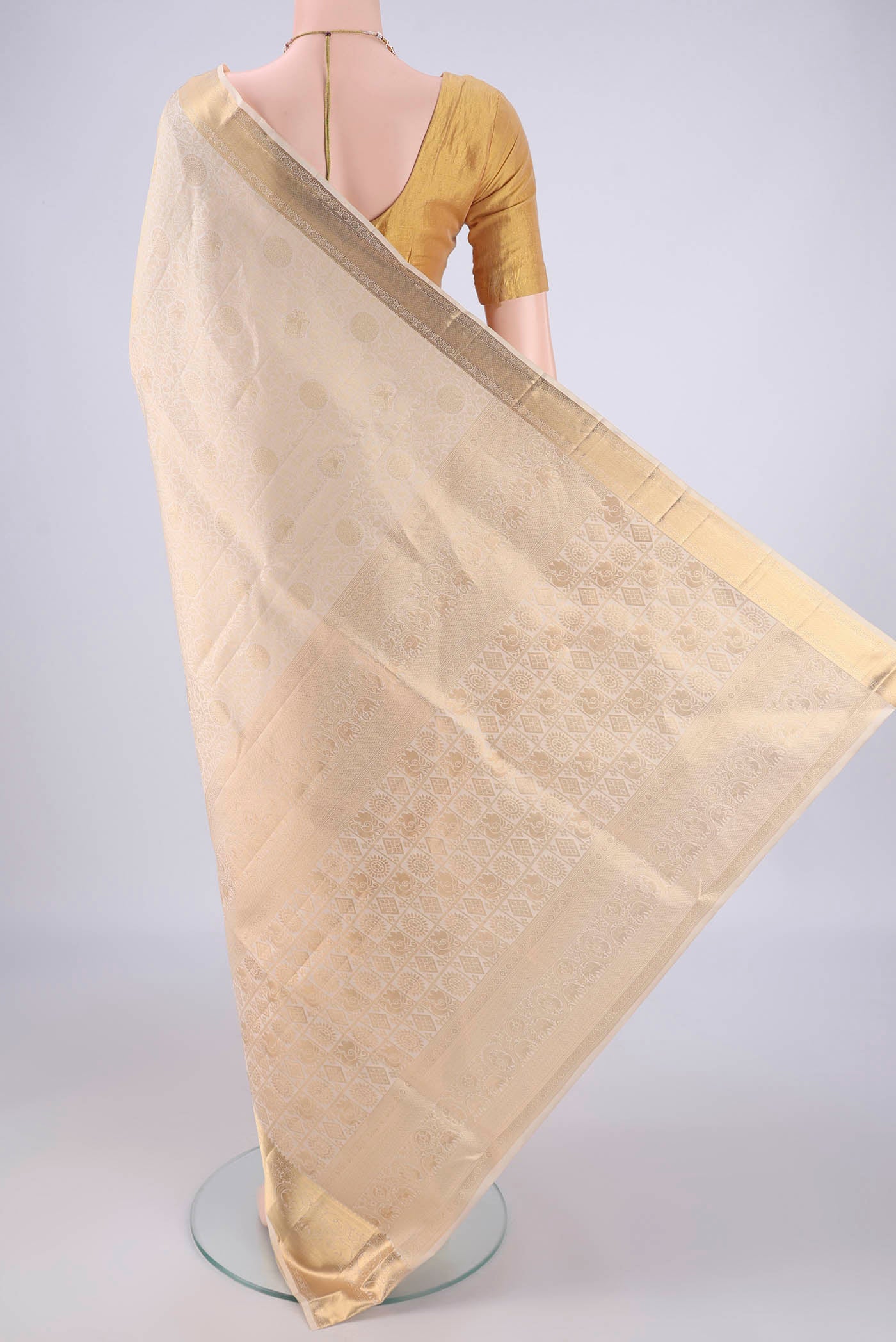 Flat view of Off White Soft Silk Saree with Zari Brocade on the body and Zari Border. 