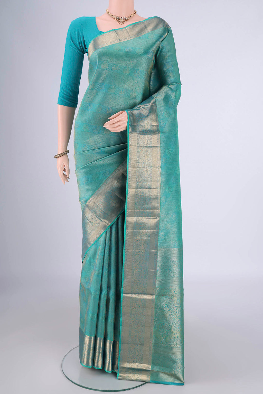 Turquoise Soft Silk Saree with Zari Brocade on the body and Zari Border.  displayed on a mannequin
