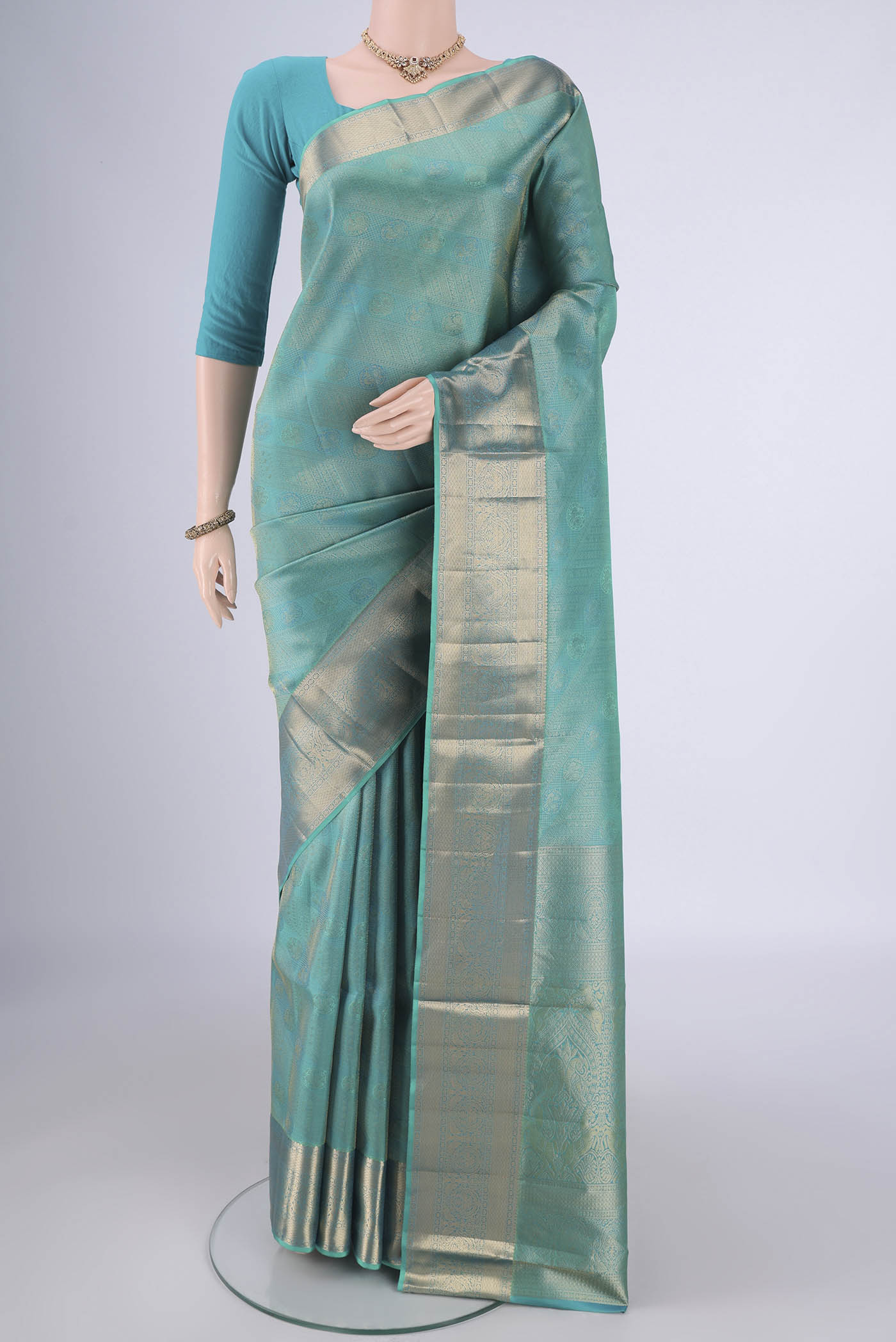 Turquoise Soft Silk Saree with Zari Brocade on the body and Zari Border.  displayed on a mannequin