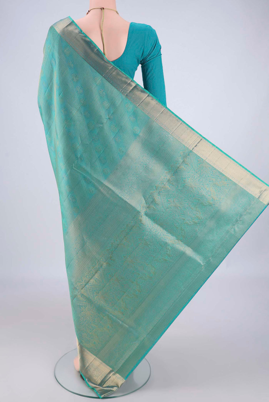 Flat view of Turquoise Soft Silk Saree with Zari Brocade on the body and Zari Border. 