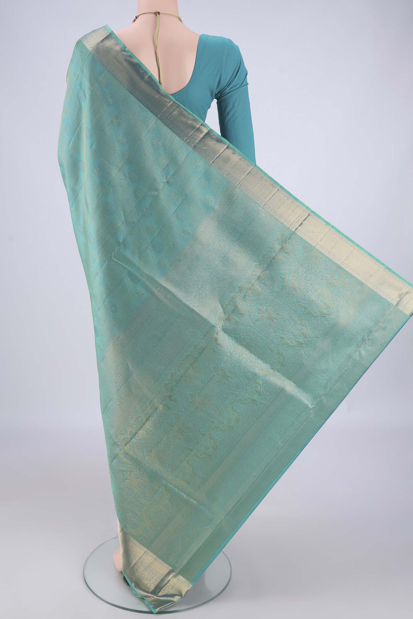 Flat view of Turquoise Soft Silk Saree with Zari Brocade on the body and Zari Border. 