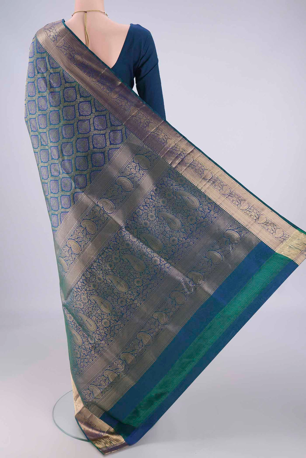 Flat view of Peacock Blue Soft Silk Saree with Zari Brocade on the body and Zari Border. 