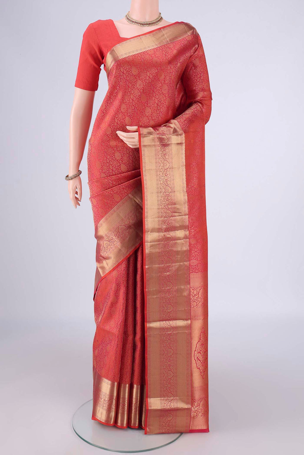 Orange Soft Silk Saree with Zari Brocade on the body and Zari Border.  displayed on a mannequin