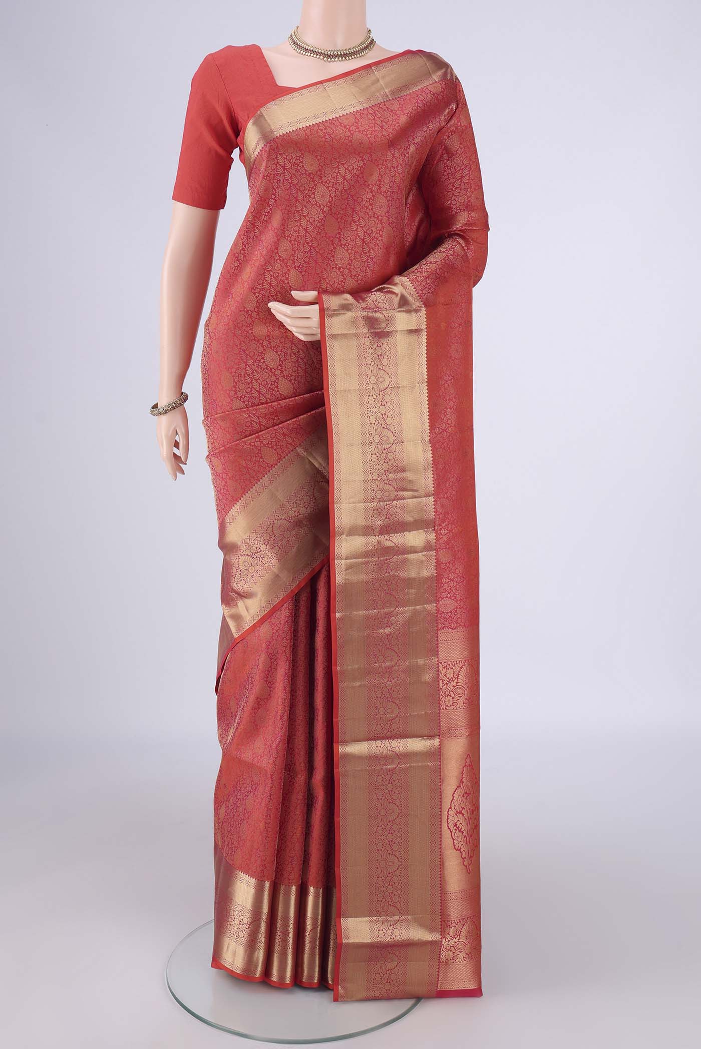 Orange Soft Silk Saree with Zari Brocade on the body and Zari Border.  displayed on a mannequin