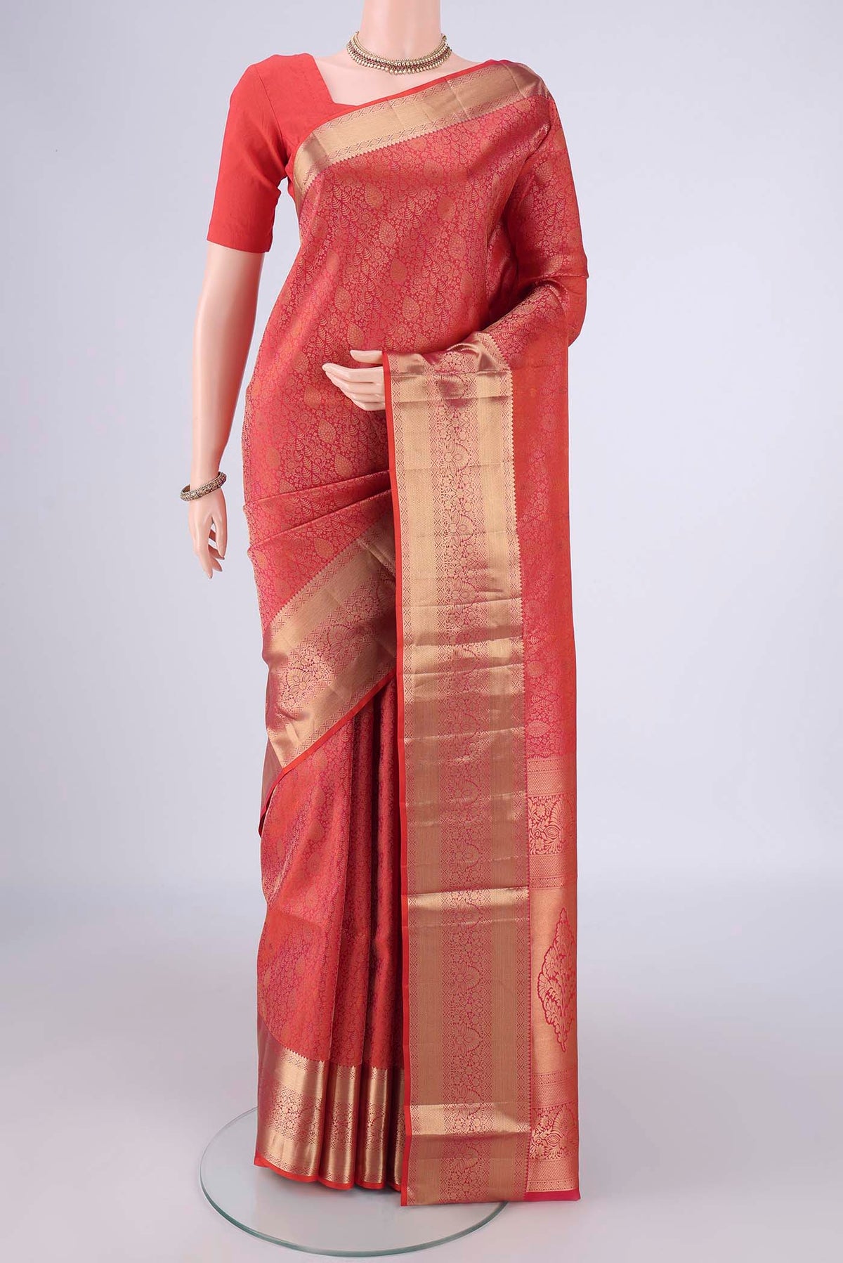 Orange Soft Silk Saree with Zari Brocade on the body and Zari Border.  displayed on a mannequin