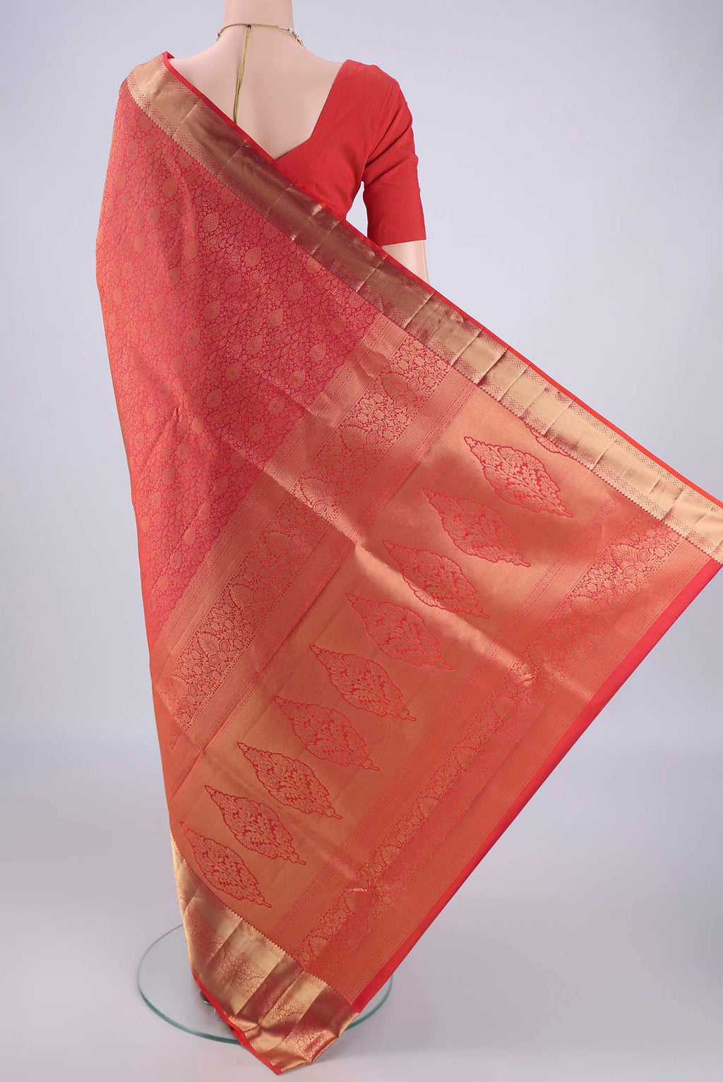 Flat view of Orange Soft Silk Saree with Zari Brocade on the body and Zari Border. 