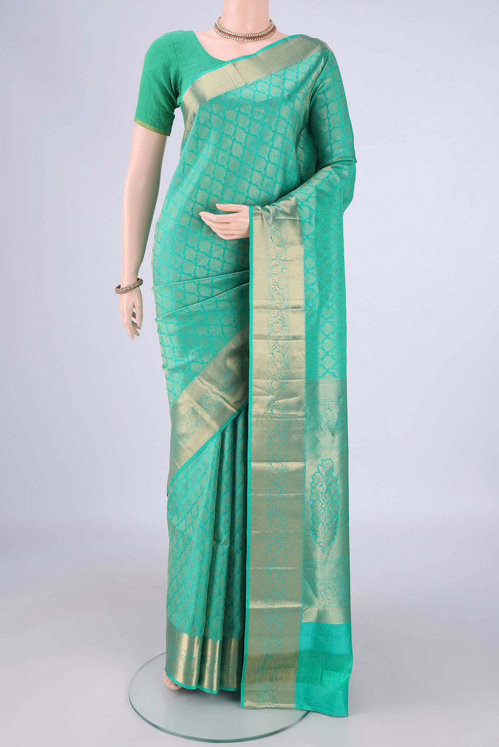 Sea Green Soft Silk Saree with Zari Brocade on the body and Zari Border.  displayed on a mannequin