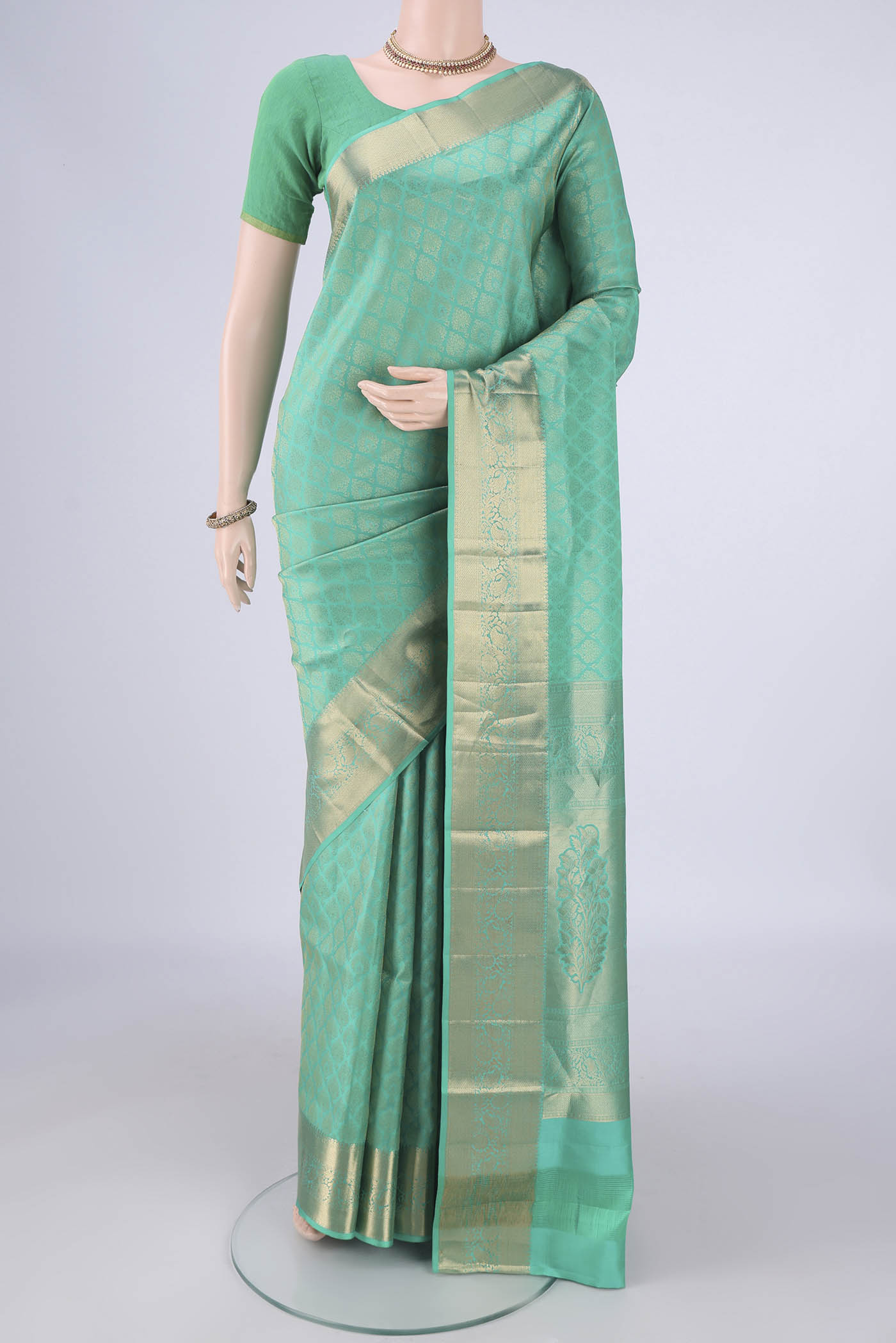 Sea Green Soft Silk Saree with Zari Brocade on the body and Zari Border.  displayed on a mannequin