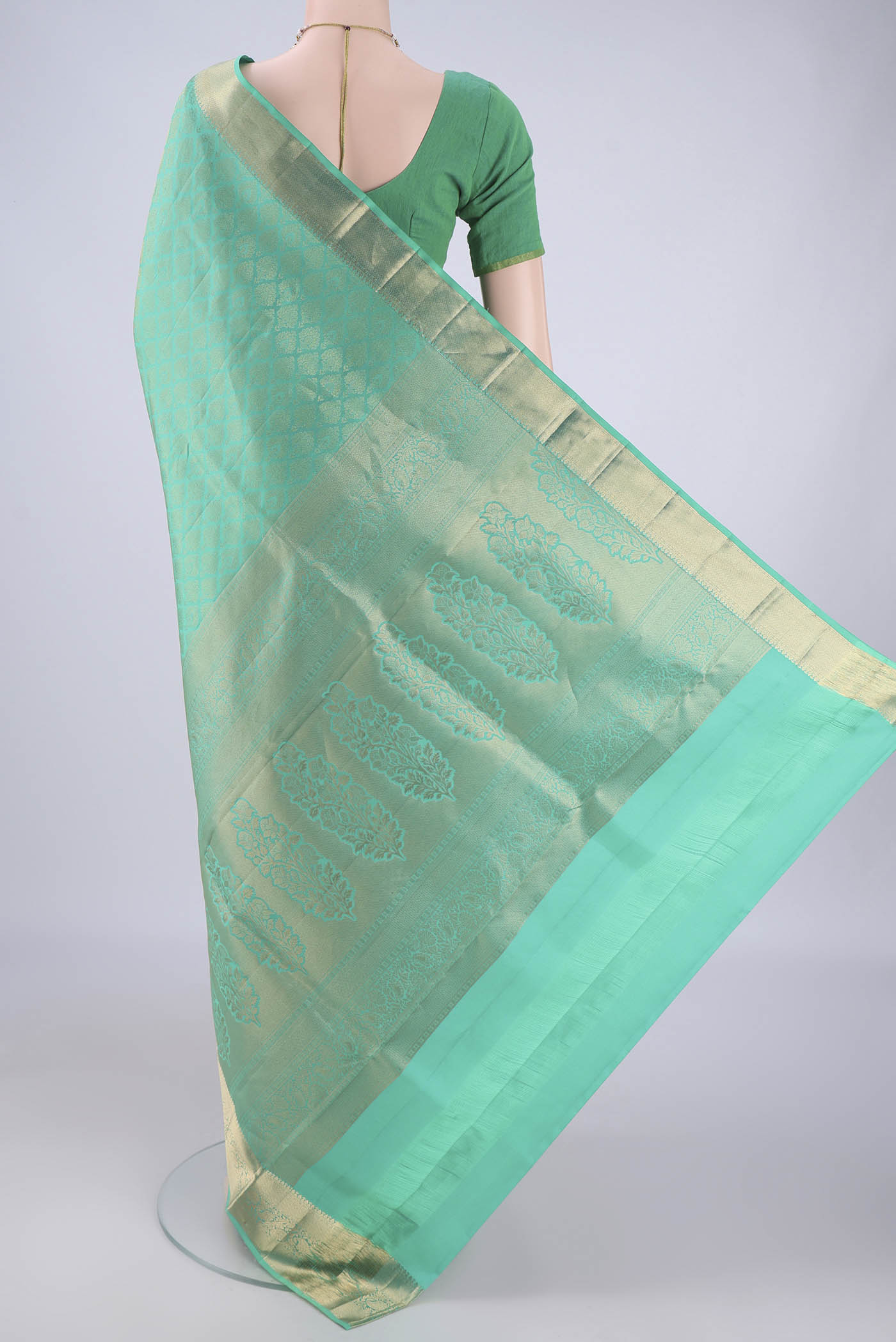 Flat view of Sea Green Soft Silk Saree with Zari Brocade on the body and Zari Border. 