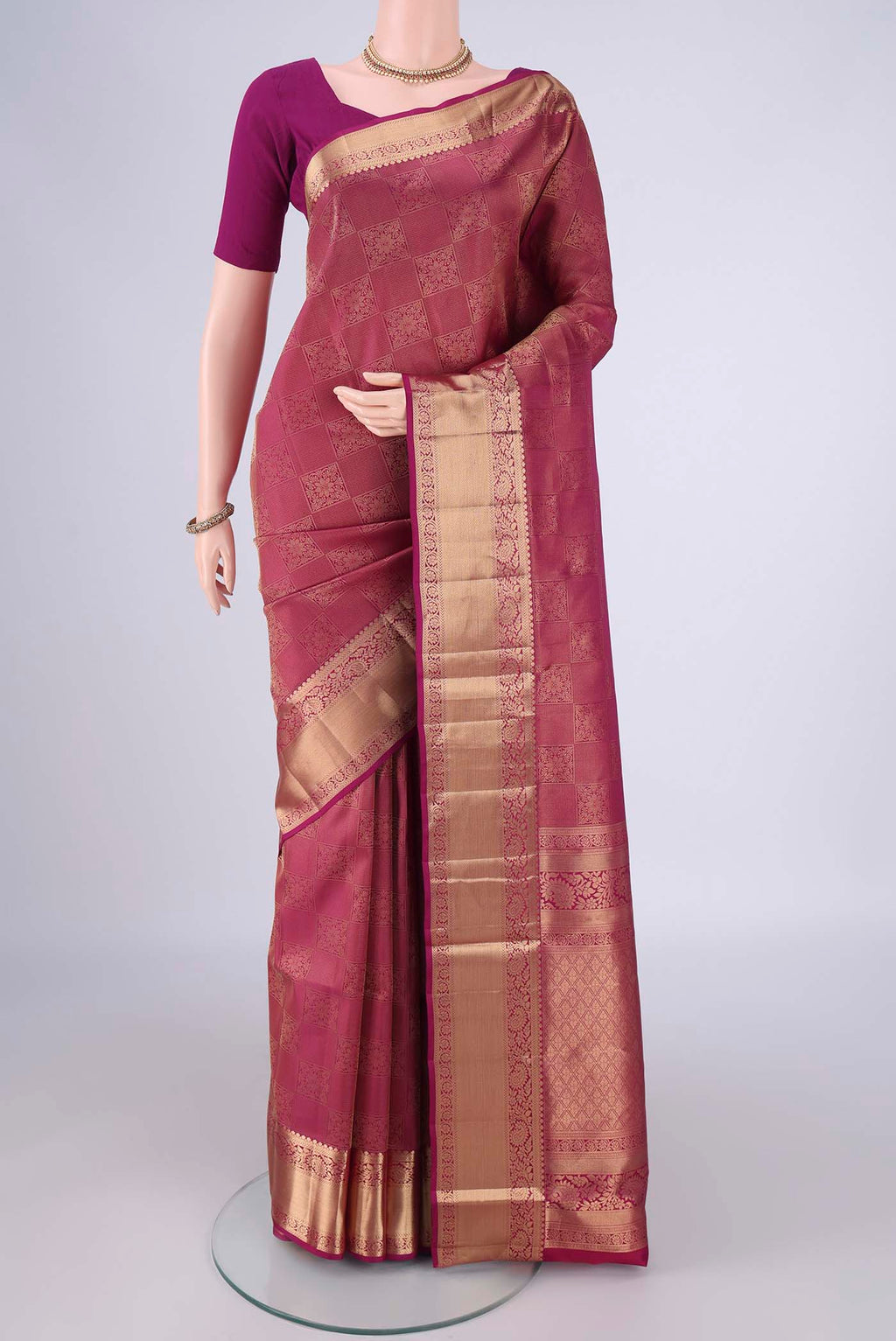 Bottle Green Soft Silk Saree with Zari Brocade on the body and Zari Border.  displayed on a mannequin