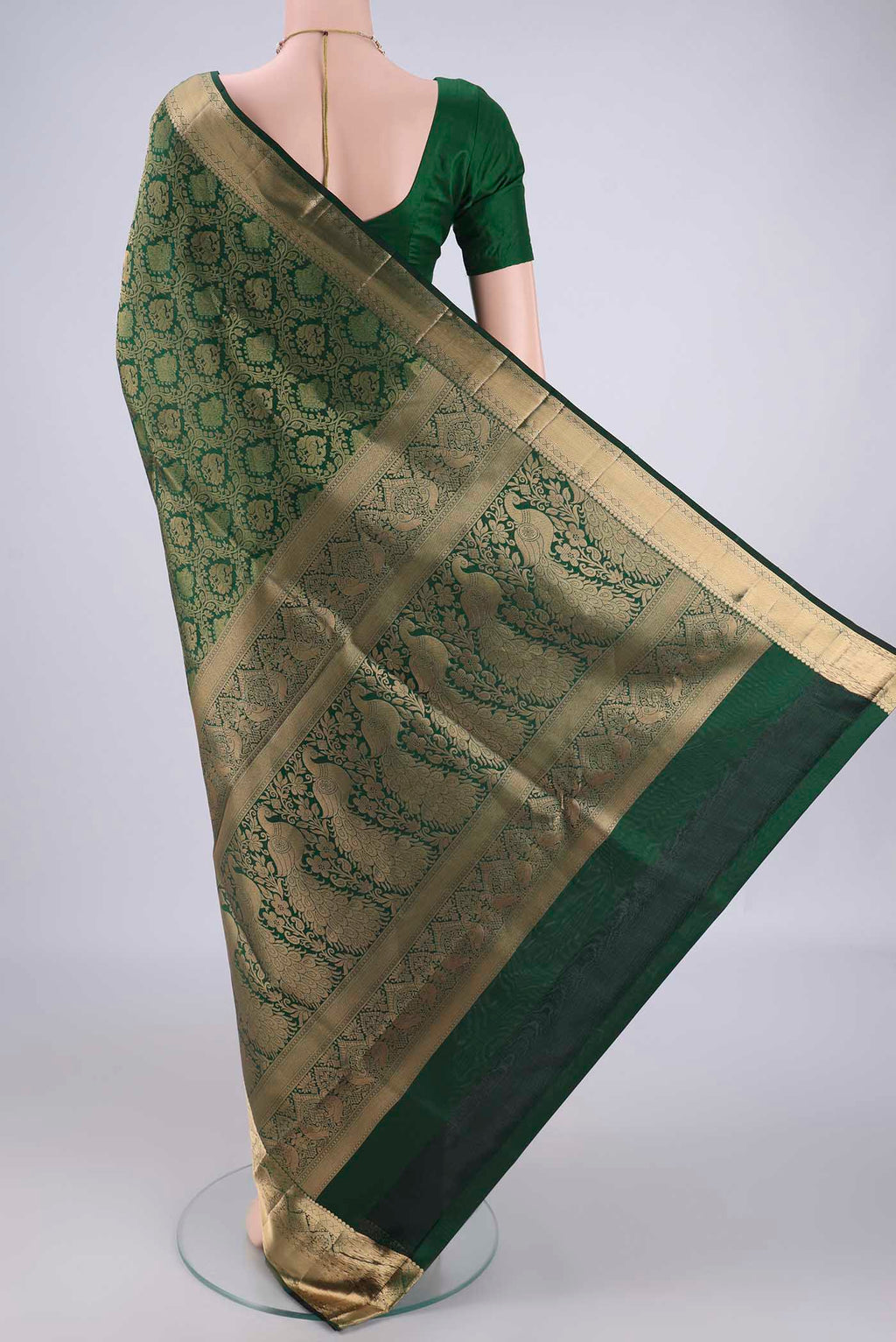 Flat view of Bottle Green Soft Silk Saree with Zari Brocade on the body and Zari Border. 