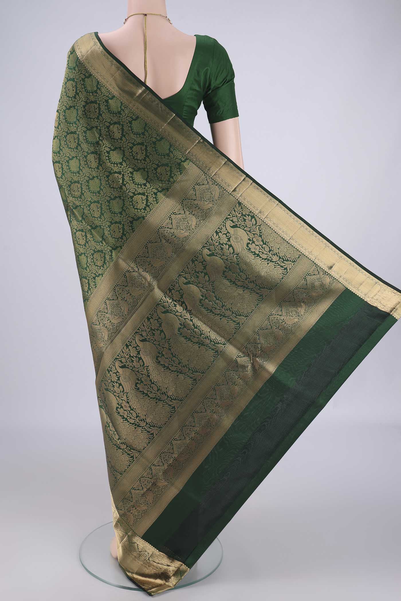 Flat view of Bottle Green Soft Silk Saree with Zari Brocade on the body and Zari Border. 
