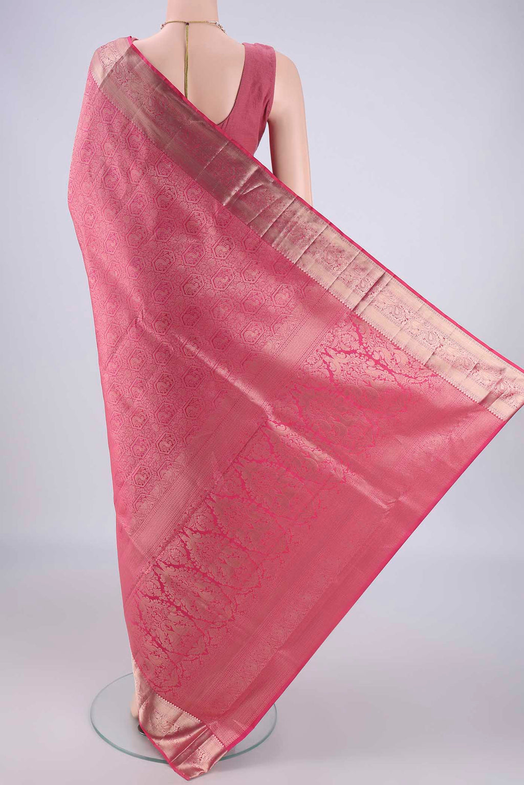 Flat view of Pink Soft Silk Saree with Zari Brocade on the body and Zari Border. 