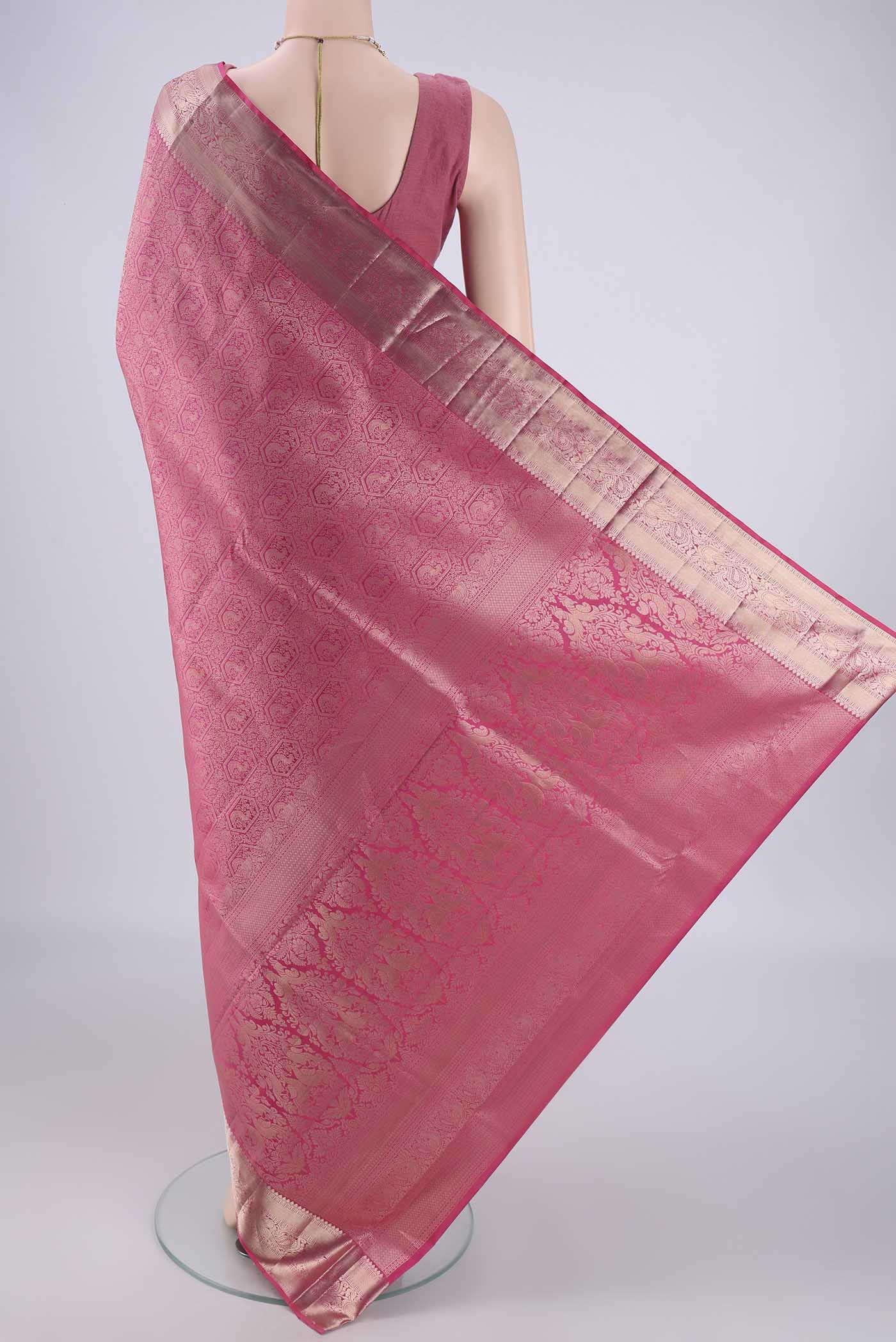 Flat view of Pink Soft Silk Saree with Zari Brocade on the body and Zari Border. 