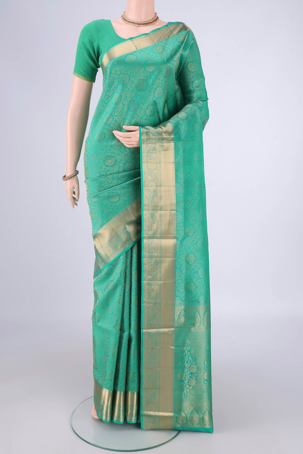 Sea Green Soft Silk Saree with Zari Brocade on the body and Zari Border.  displayed on a mannequin
