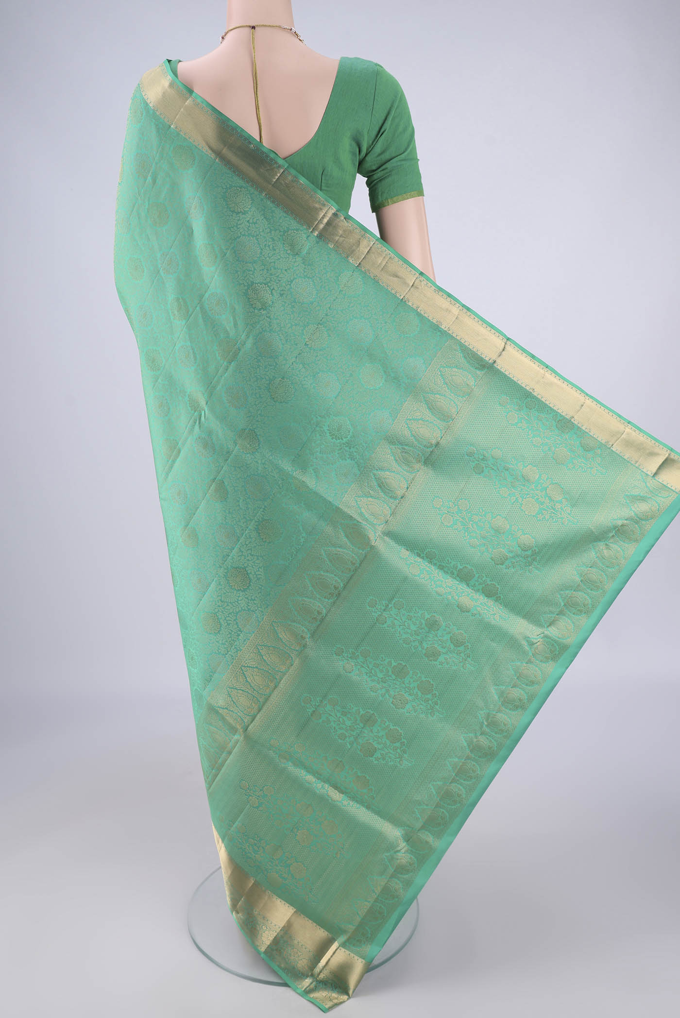 Flat view of Sea Green Soft Silk Saree with Zari Brocade on the body and Zari Border. 