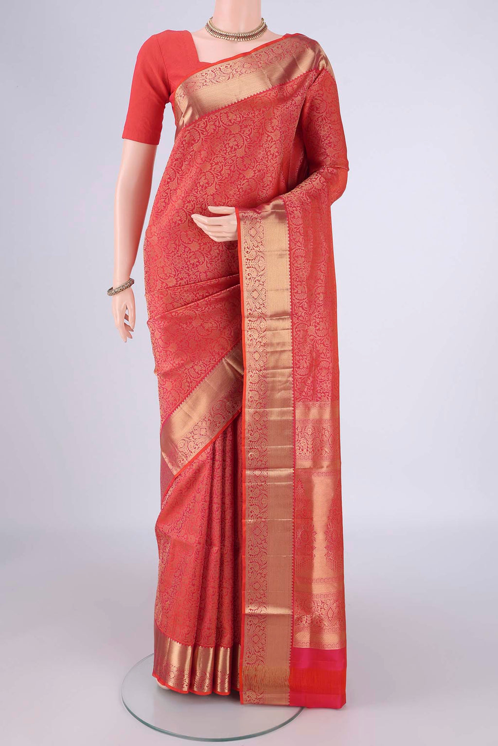Orange Soft Silk Saree with Zari Brocade on the body and Zari Border.  displayed on a mannequin