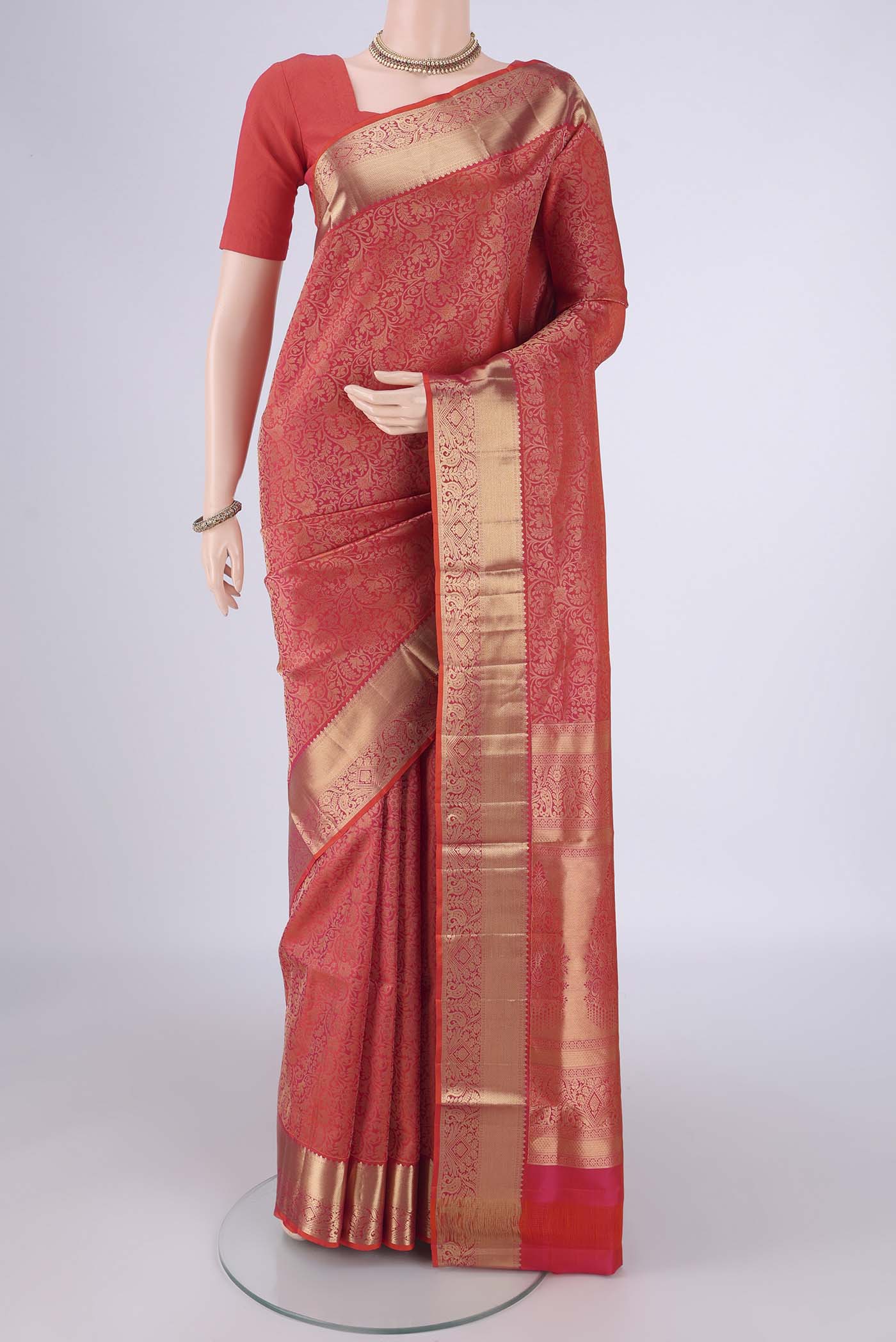 Orange Soft Silk Saree with Zari Brocade on the body and Zari Border.  displayed on a mannequin