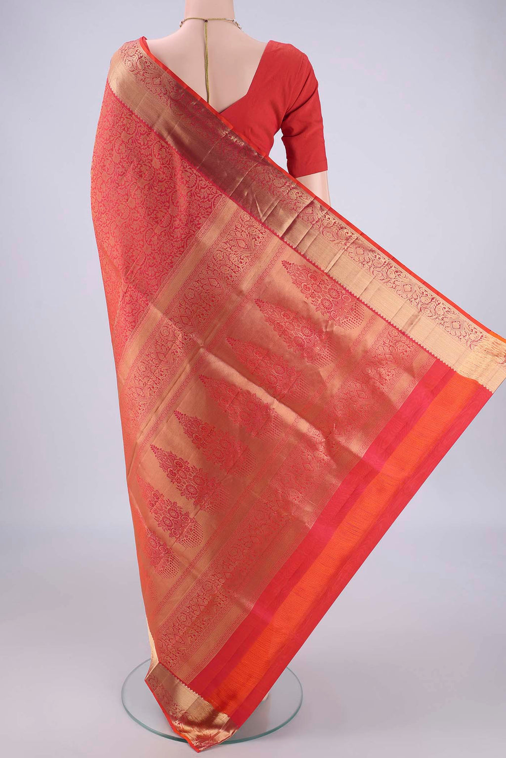 Flat view of Orange Soft Silk Saree with Zari Brocade on the body and Zari Border. 