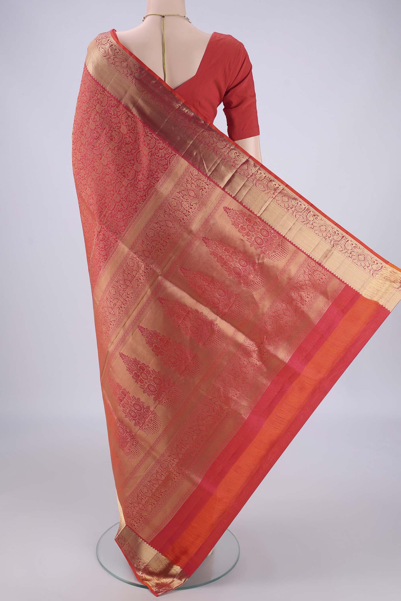 Flat view of Orange Soft Silk Saree with Zari Brocade on the body and Zari Border. 