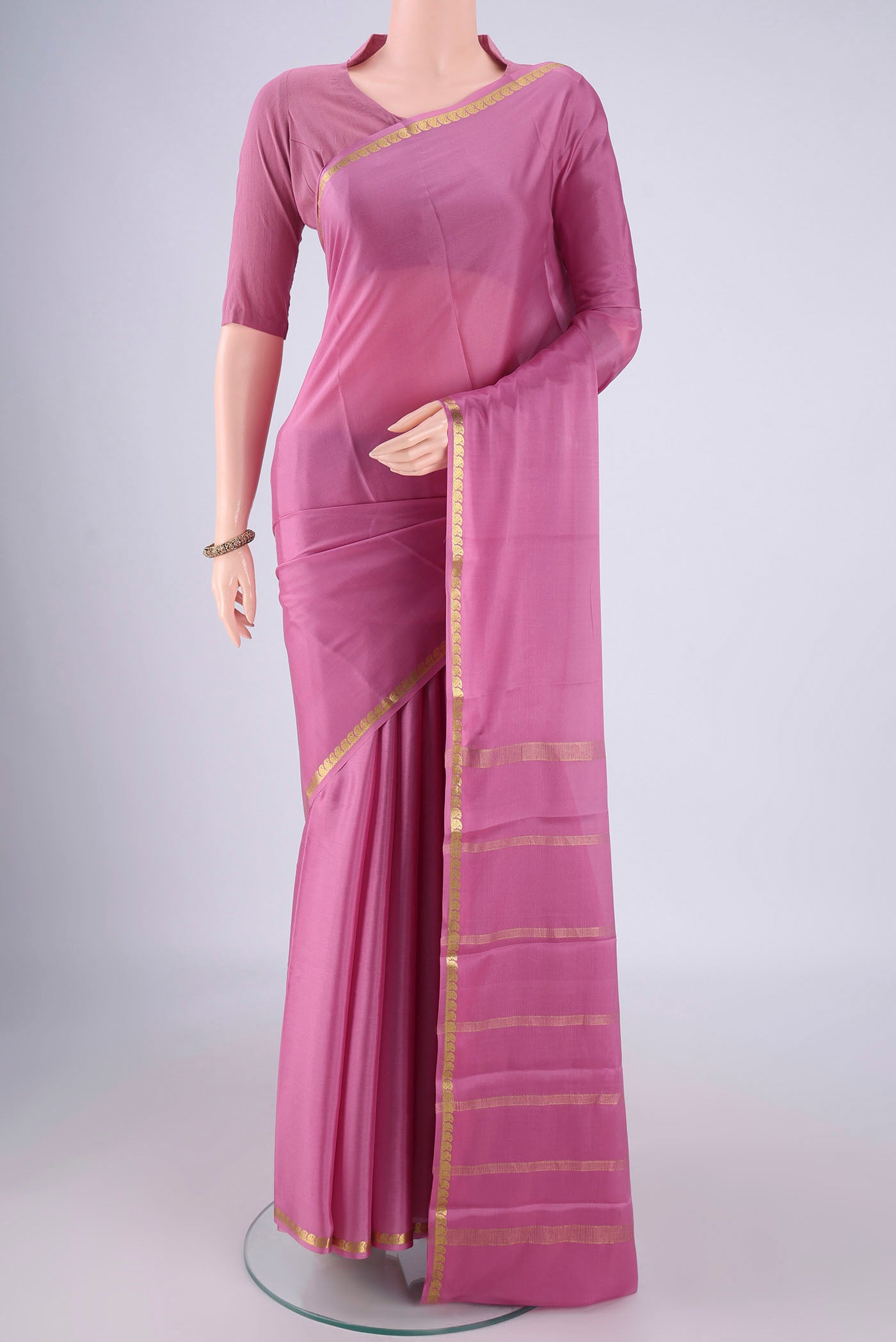Mauve Mysore Crepe Saree with Plain Body and Zari Border.  displayed on a mannequin