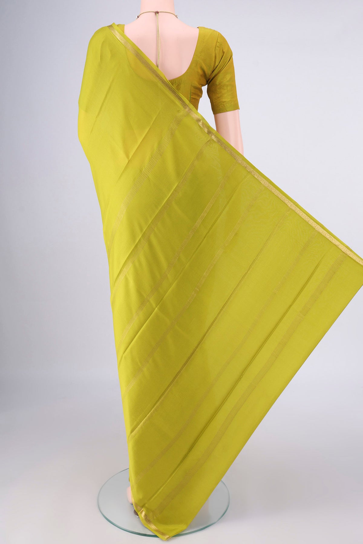 Flat view of Parrot Green Mysore Crepe Saree with Plain Body and Zari Border. 