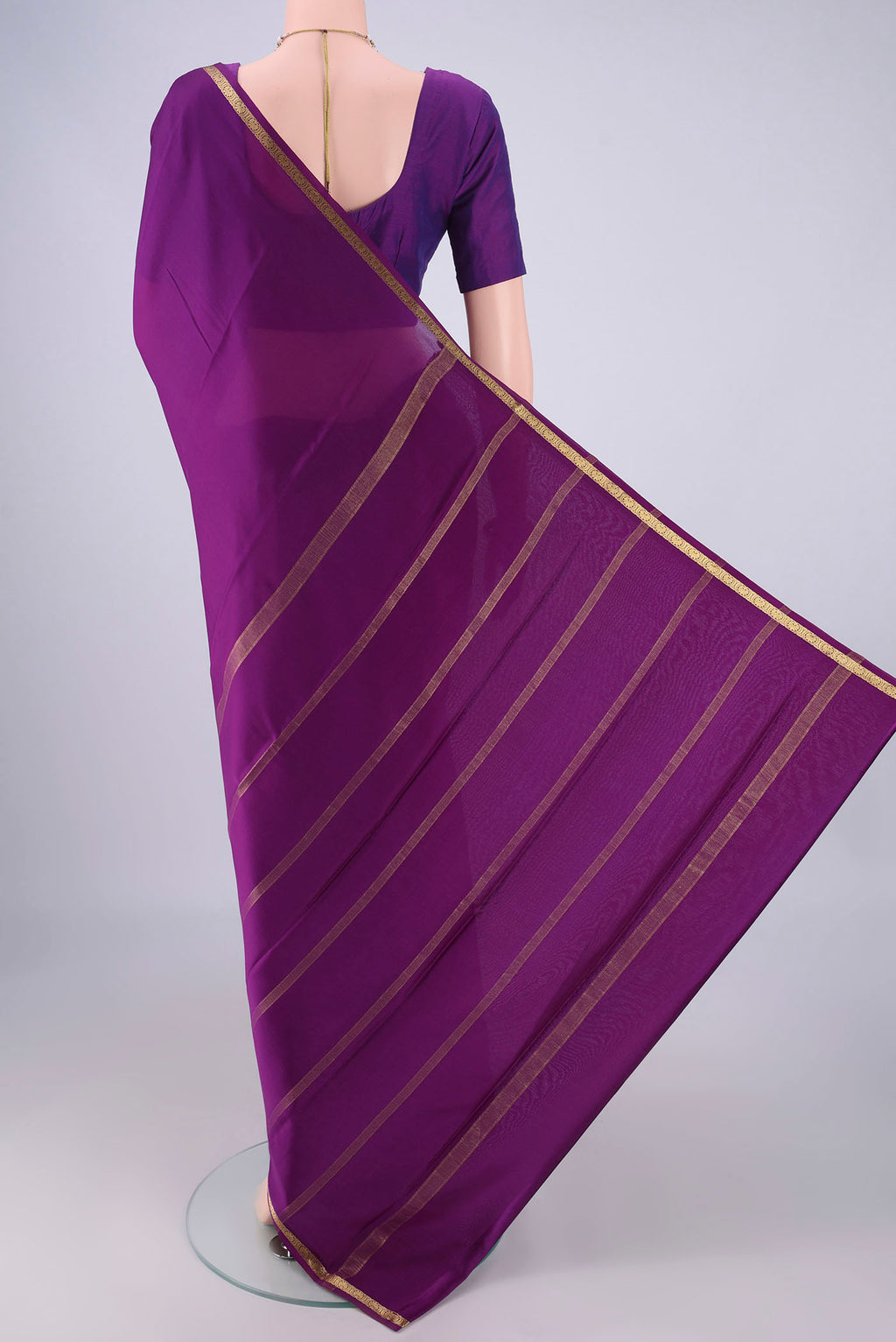 Flat view of Purple Mysore Crepe Saree with Plain Body and Zari Border. 