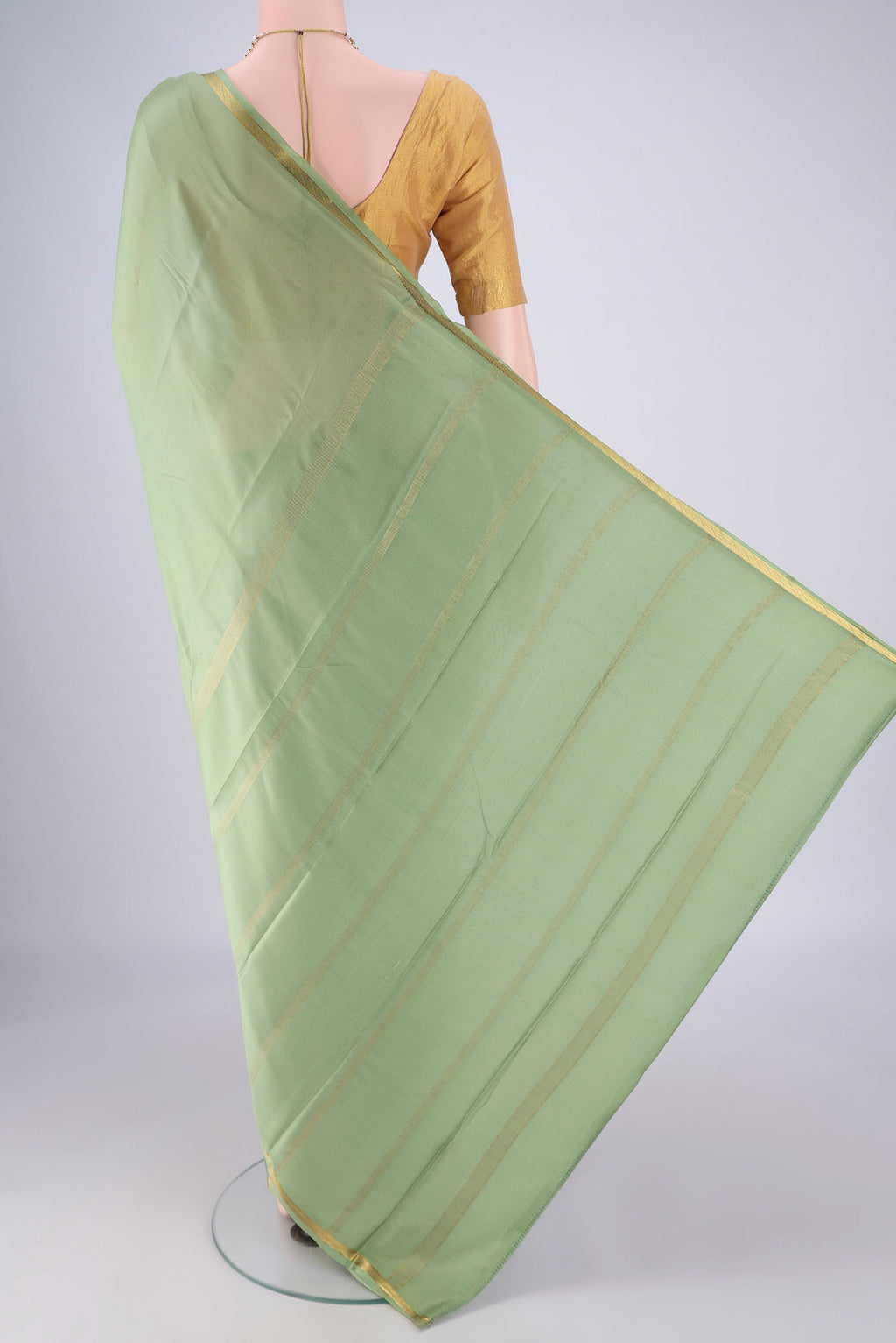 Flat view of Pista Green Mysore Crepe Saree with Plain Body and Zari Border. 