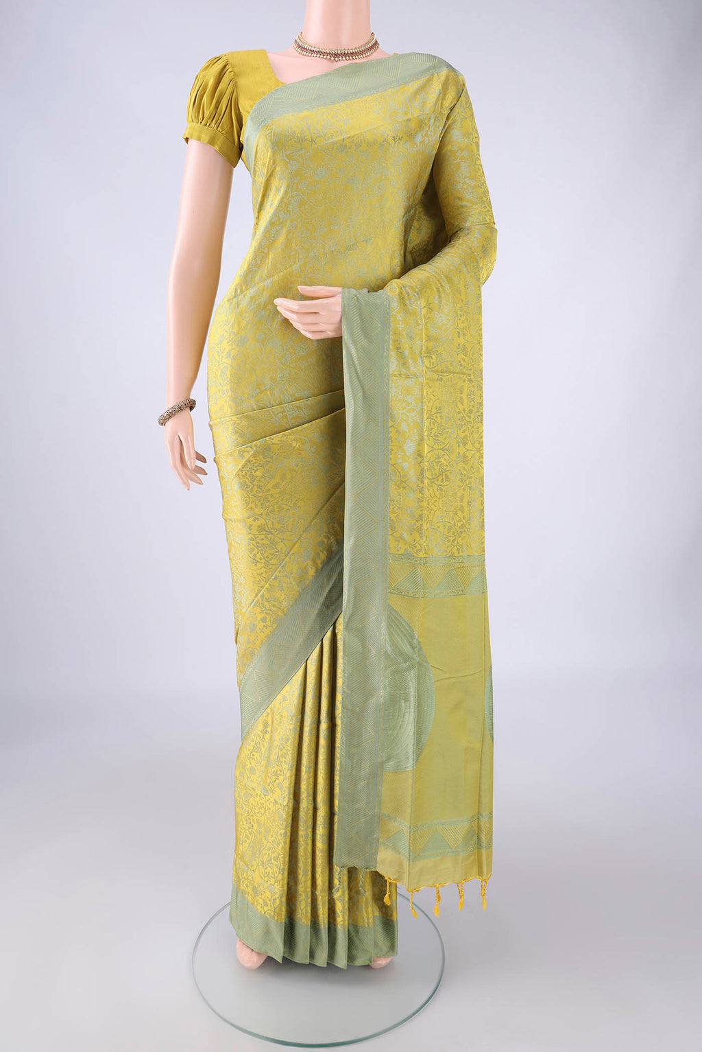Acid Green Soft Silk Saree with Thread Brocade on the body and Thread Border.  displayed on a mannequin