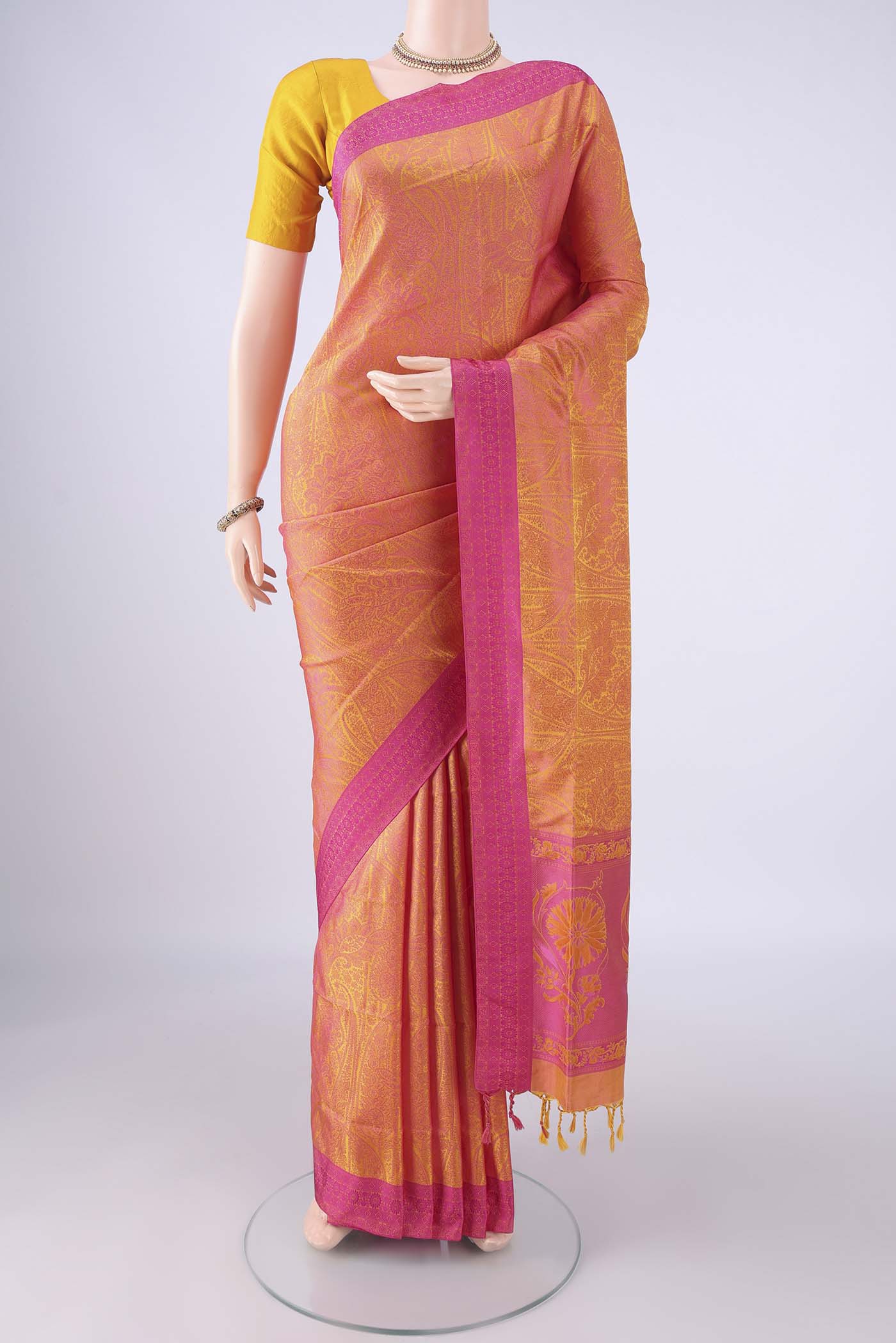 Pinkish Yellow Soft Silk Saree with Jacquard design on the body and Thread Border.  displayed on a mannequin