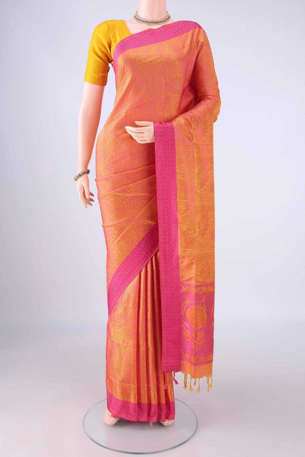 Pinkish Yellow Soft Silk Saree with Jacquard design on the body and Thread Border.  displayed on a mannequin