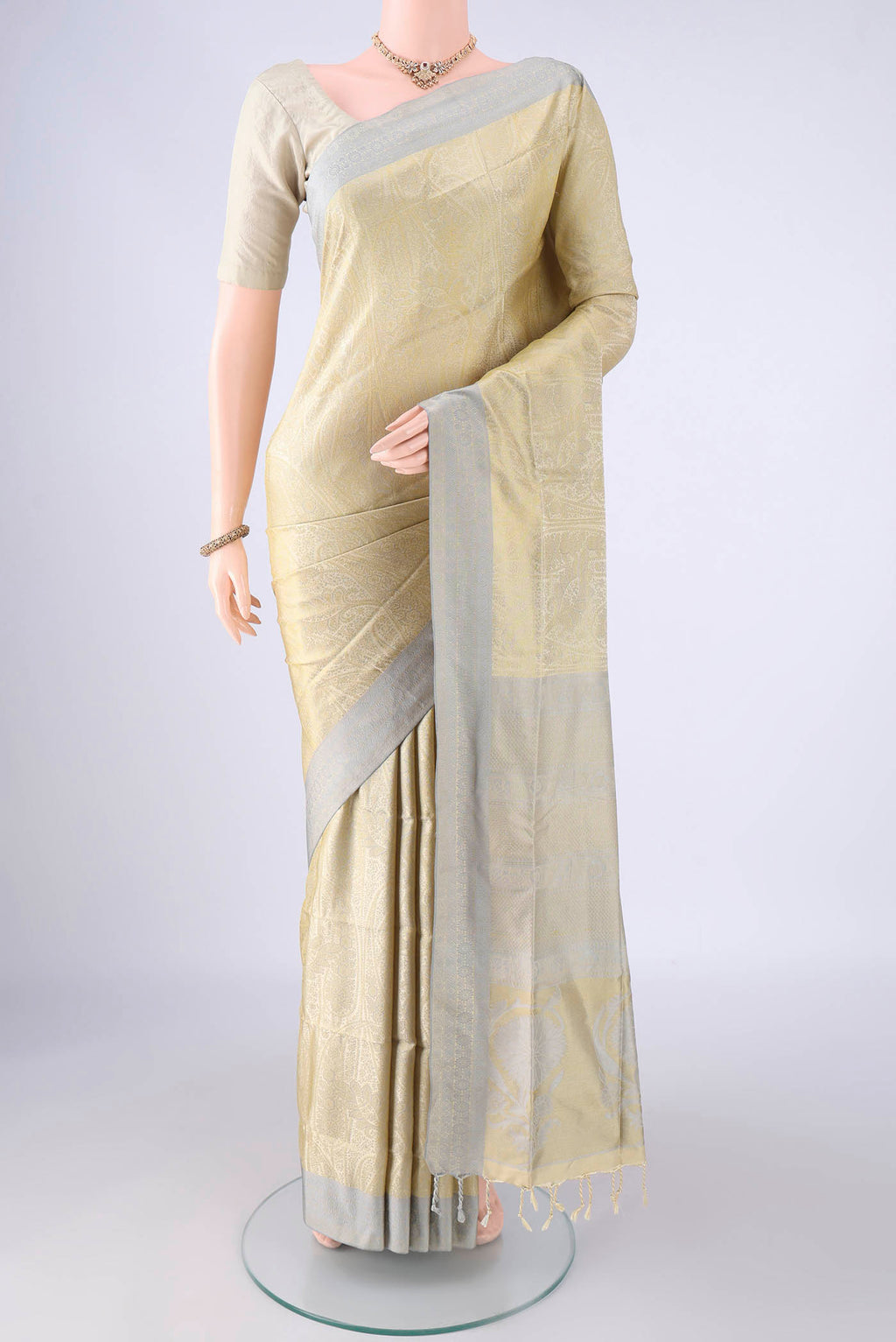 Beige Dual Tone Soft Silk Saree with Jacquard design on the body and Thread Border.  displayed on a mannequin