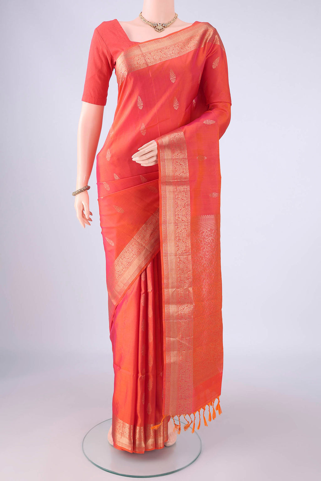 Coral Dual Tone Soft Silk Saree with Zari Butta on the body and Zari Border.  displayed on a mannequin