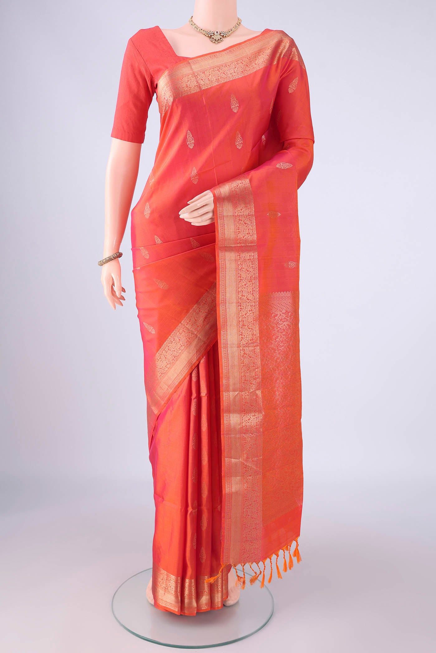Coral Dual Tone Soft Silk Saree with Zari Butta on the body and Zari Border.  displayed on a mannequin
