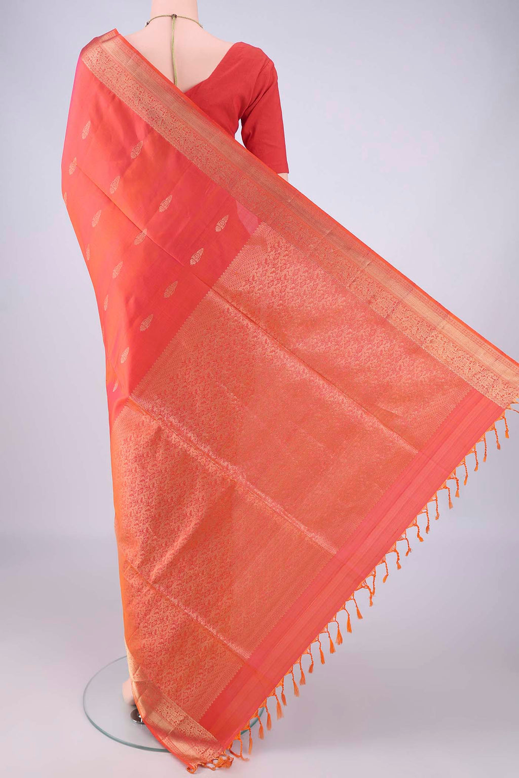 Flat view of Coral Dual Tone Soft Silk Saree with Zari Butta on the body and Zari Border. 