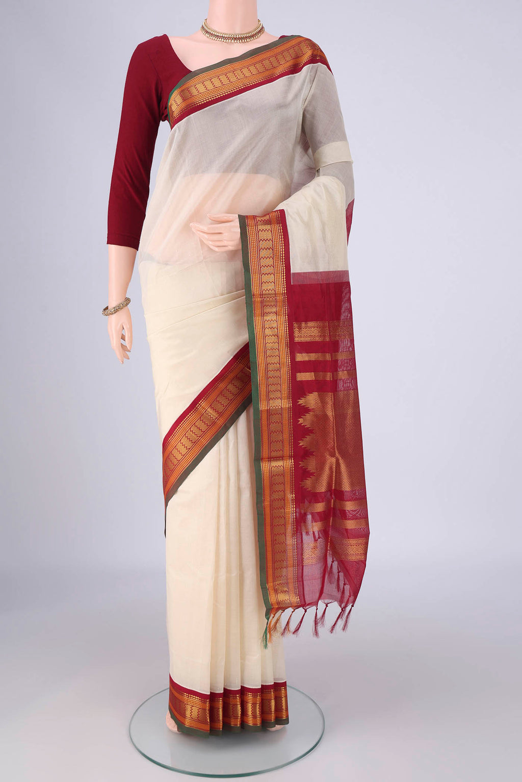 Cream Coimbatore Silk Cotton Saree with Plain Body and Zari Border.  displayed on a mannequin