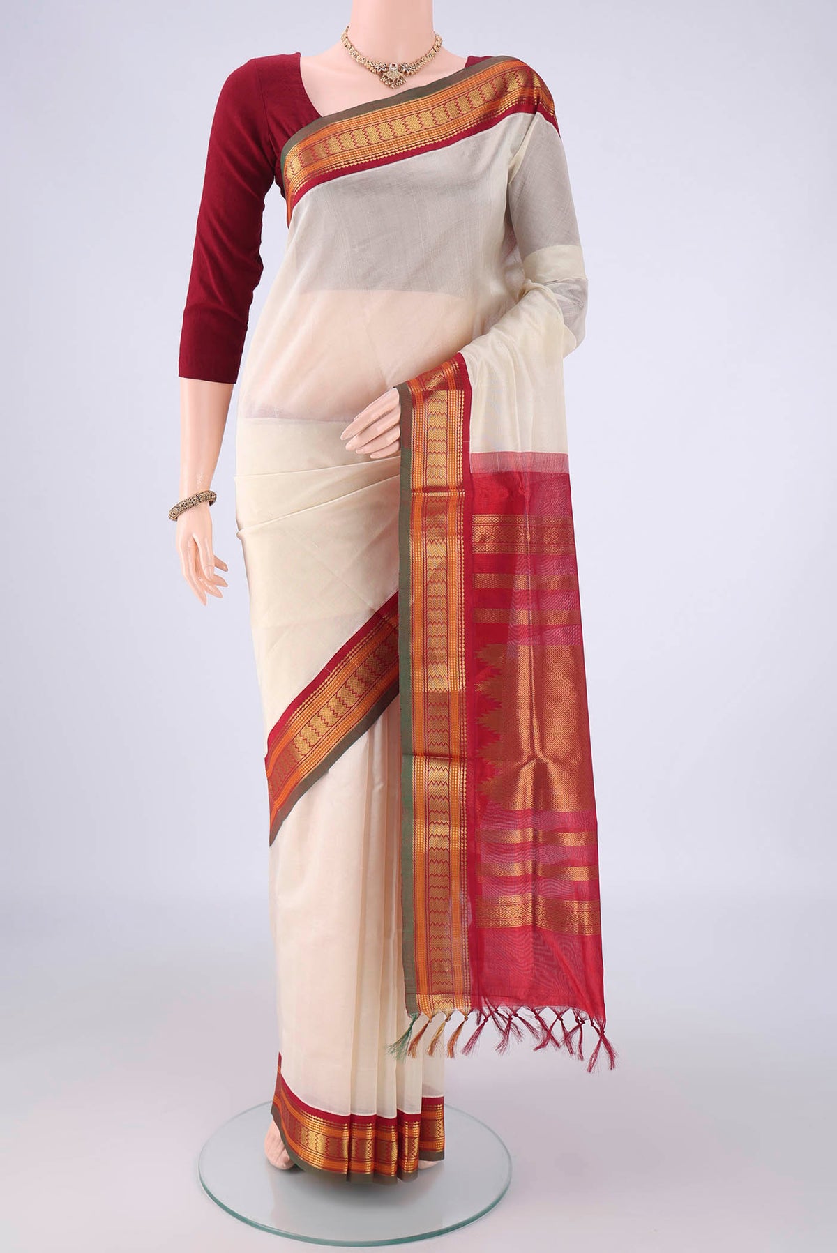 Off White Coimbatore Silk Cotton Saree with Plain Body and Zari Border.  displayed on a mannequin
