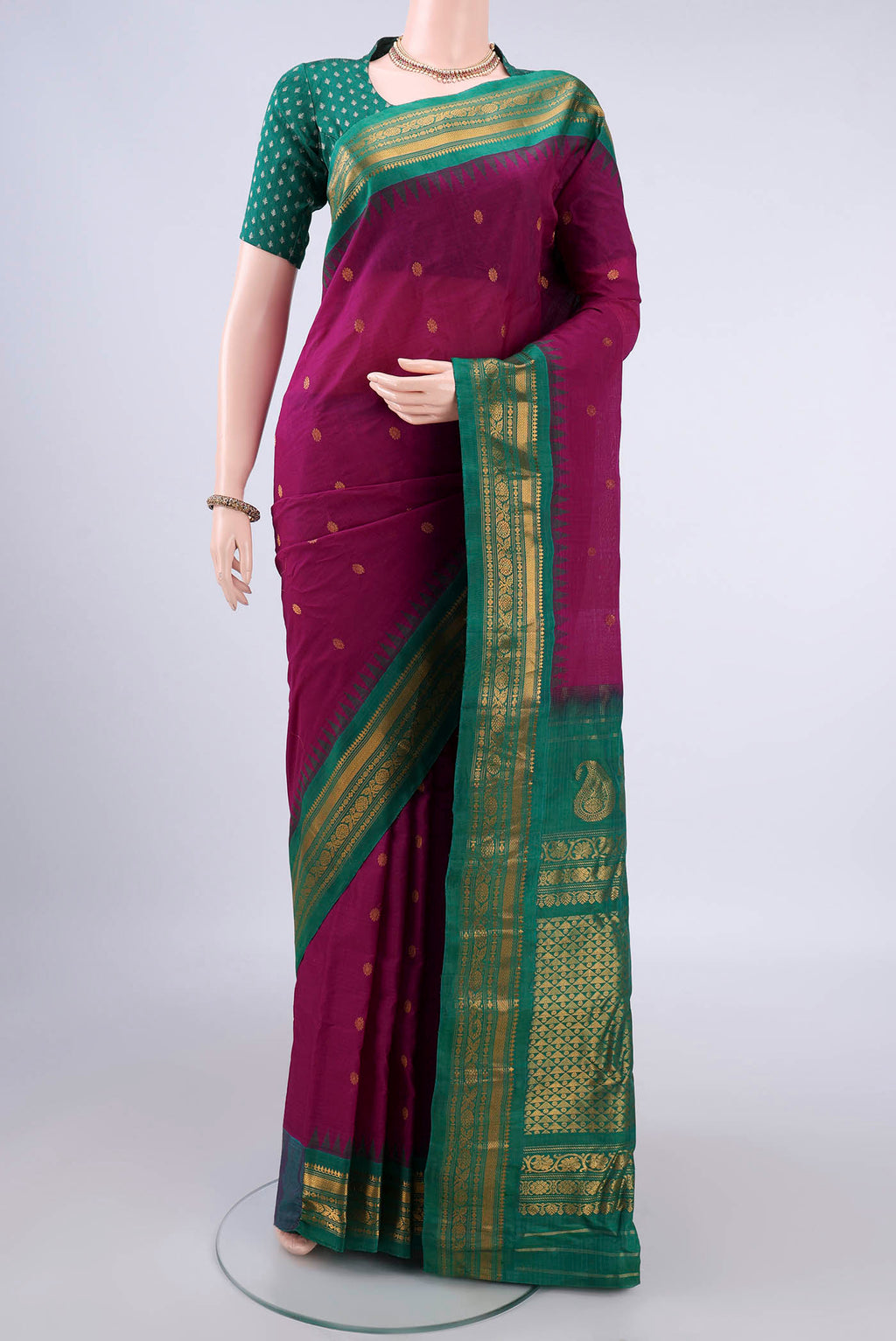 Magenta Gadwal Cotton Saree with Zari Butta on the body and Zari Border.  displayed on a mannequin