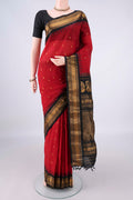 Red Gadwal Cotton Saree with Checked design on the body and Zari Border.  displayed on a mannequin