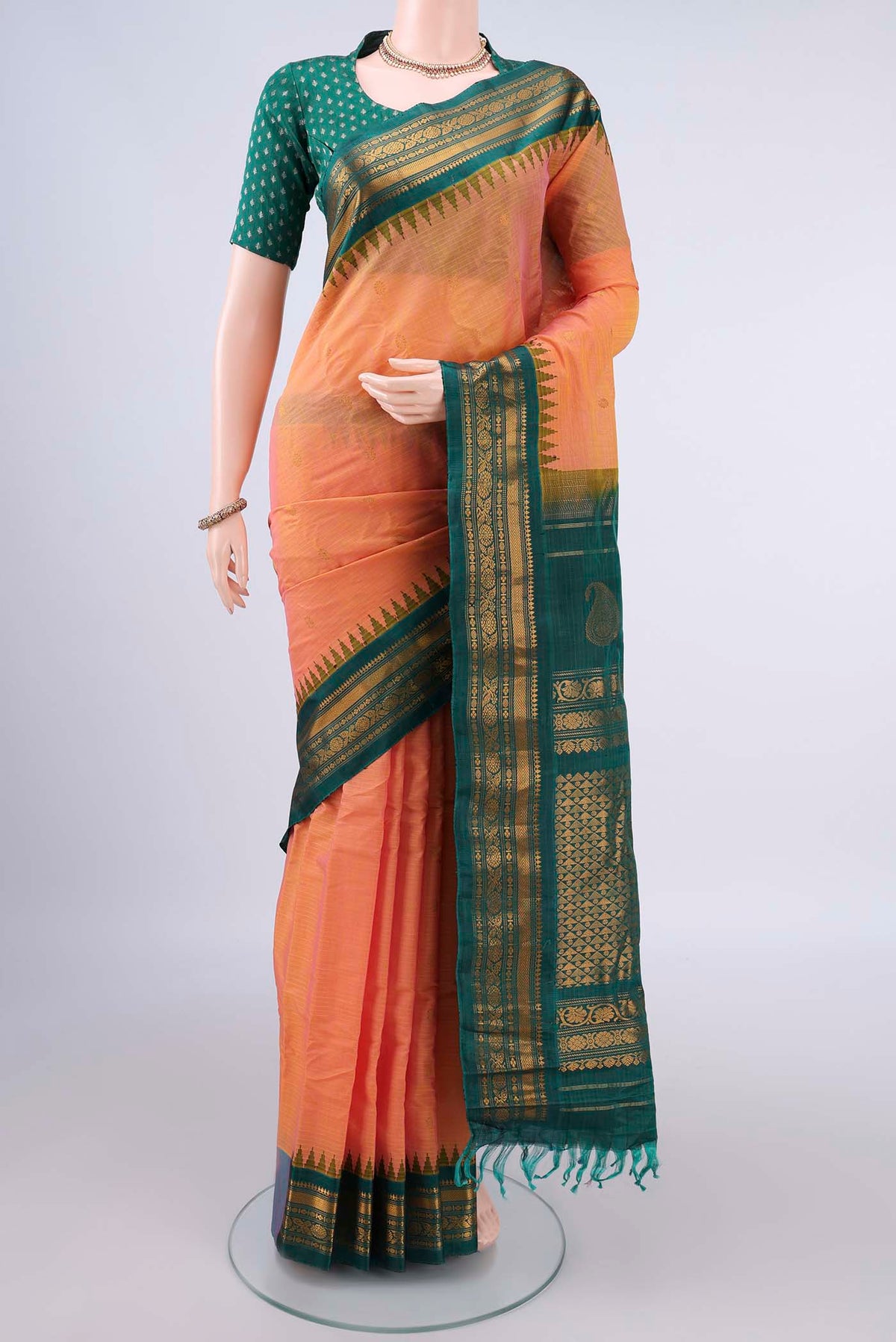 Peach Gadwal Cotton Saree with Zari Butta on the body and Zari Border.  displayed on a mannequin