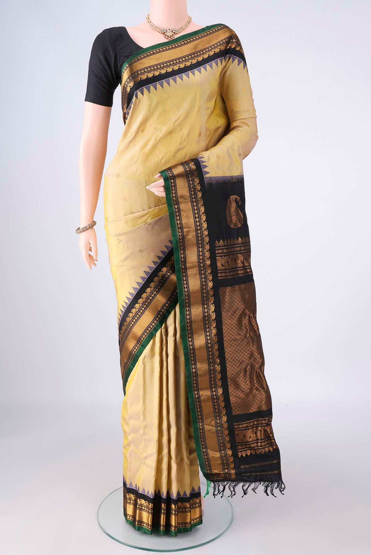 Pure Silk Sandal Gadwal Saree with Zari Butta on the body and Zari Border.  displayed on a mannequin